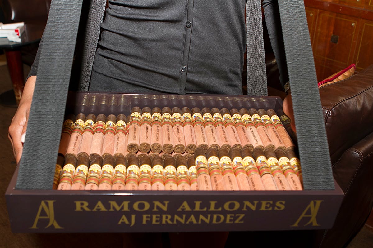 A server offers the new Ramon Allones smoke to guests at Club Macanudo.