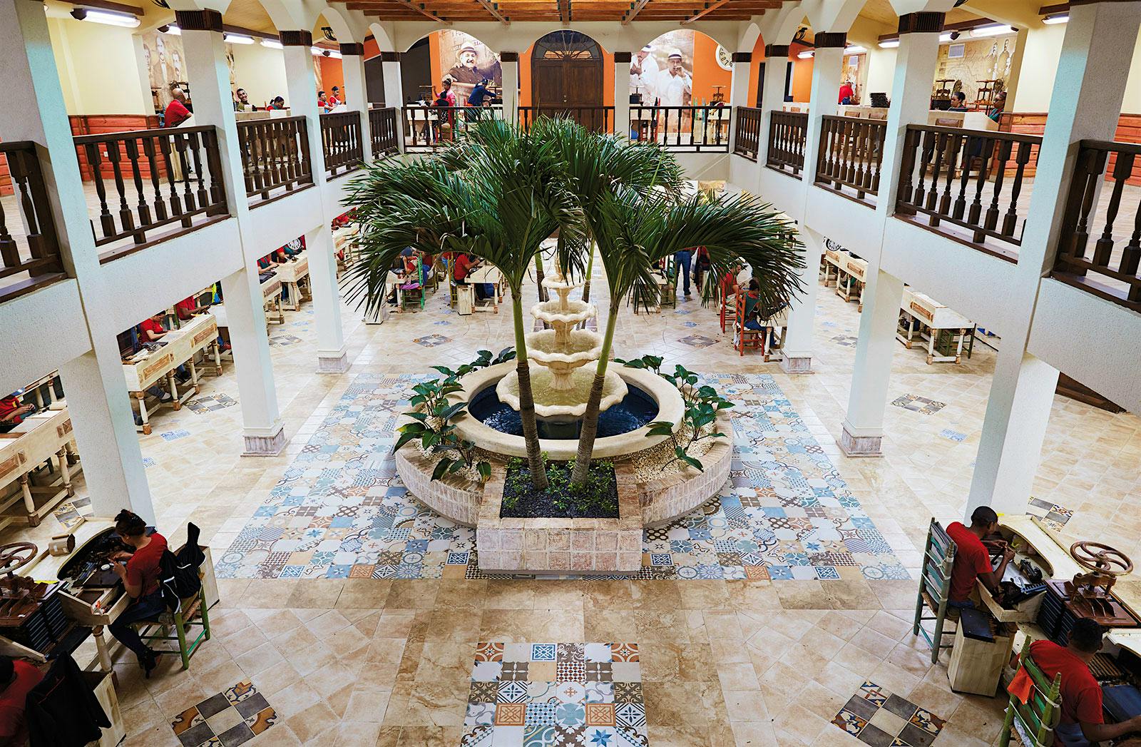 A view from the upper level of the grand courtyard. The fountain brings a tranquil air as rollers make cigars on both floors of the “cathedral of tobacco.”