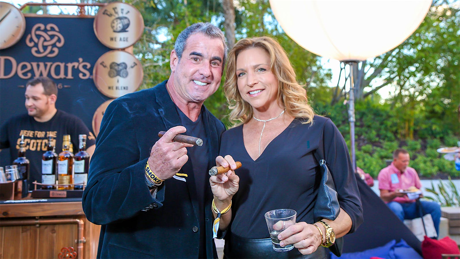 Shannon Quigley and Michael Marin enjoy a cigar with their drinks during the event.