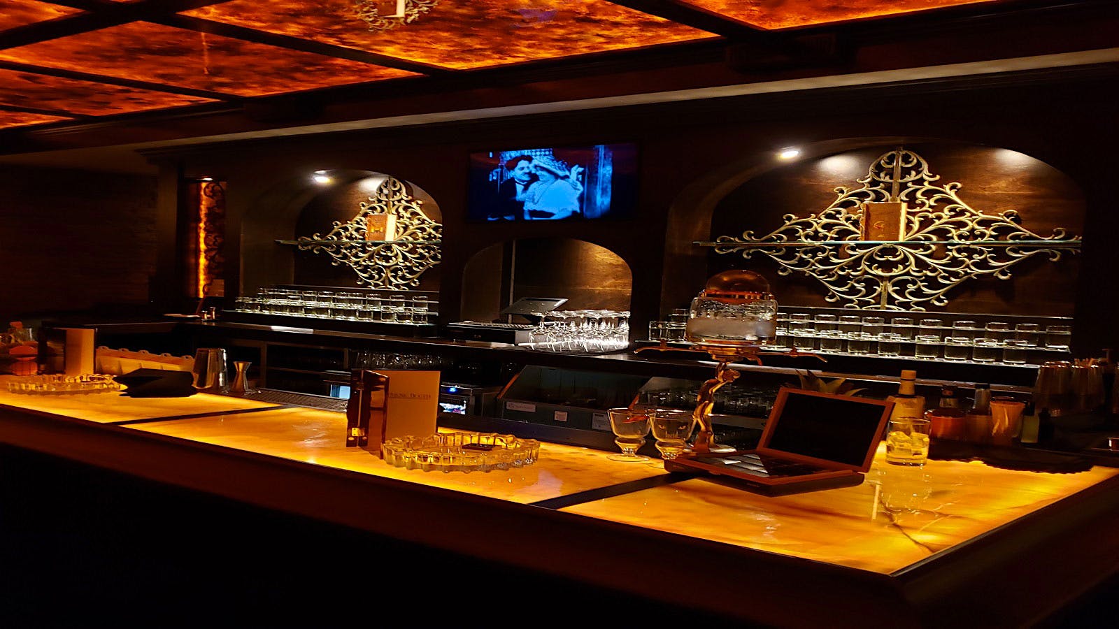 The honey-onyx bar is the focal point of the room, where drink mixing is raised to an art form.