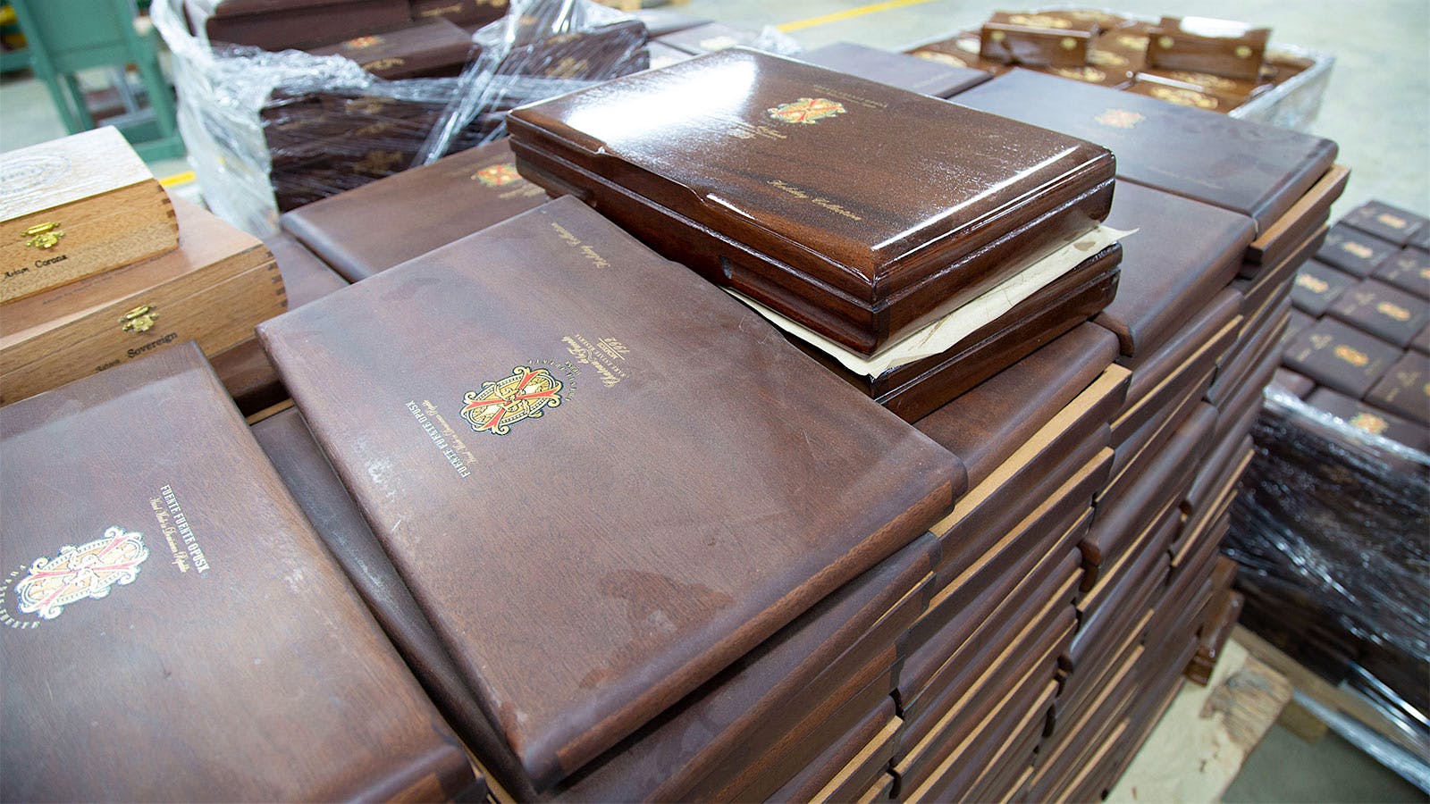 A stack of Fuente Fuente OpusX boxes that will soon be lacquered like the shiny one on top.