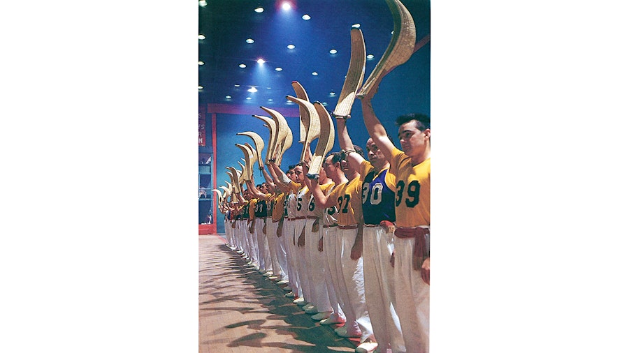 Visions of the past glory days of jai alai: the players line up and salute a crowd in Miami with their cestas before a match, circa 1960.