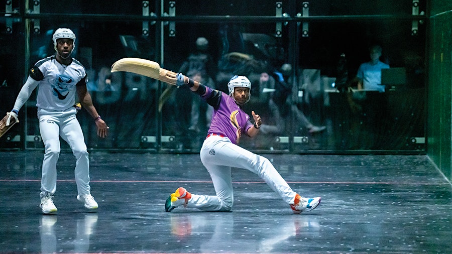 Wielding the curved wicker basket known as a cesta, a jai alai player returns a shot at Magic City. 
