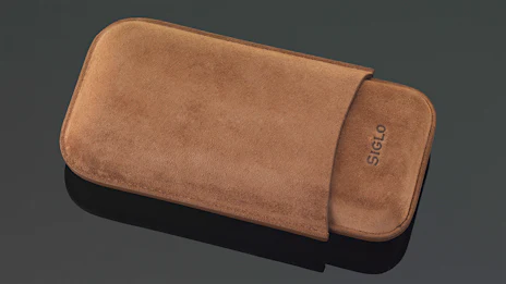 A Suede Cigar Case And Lighter From Siglo