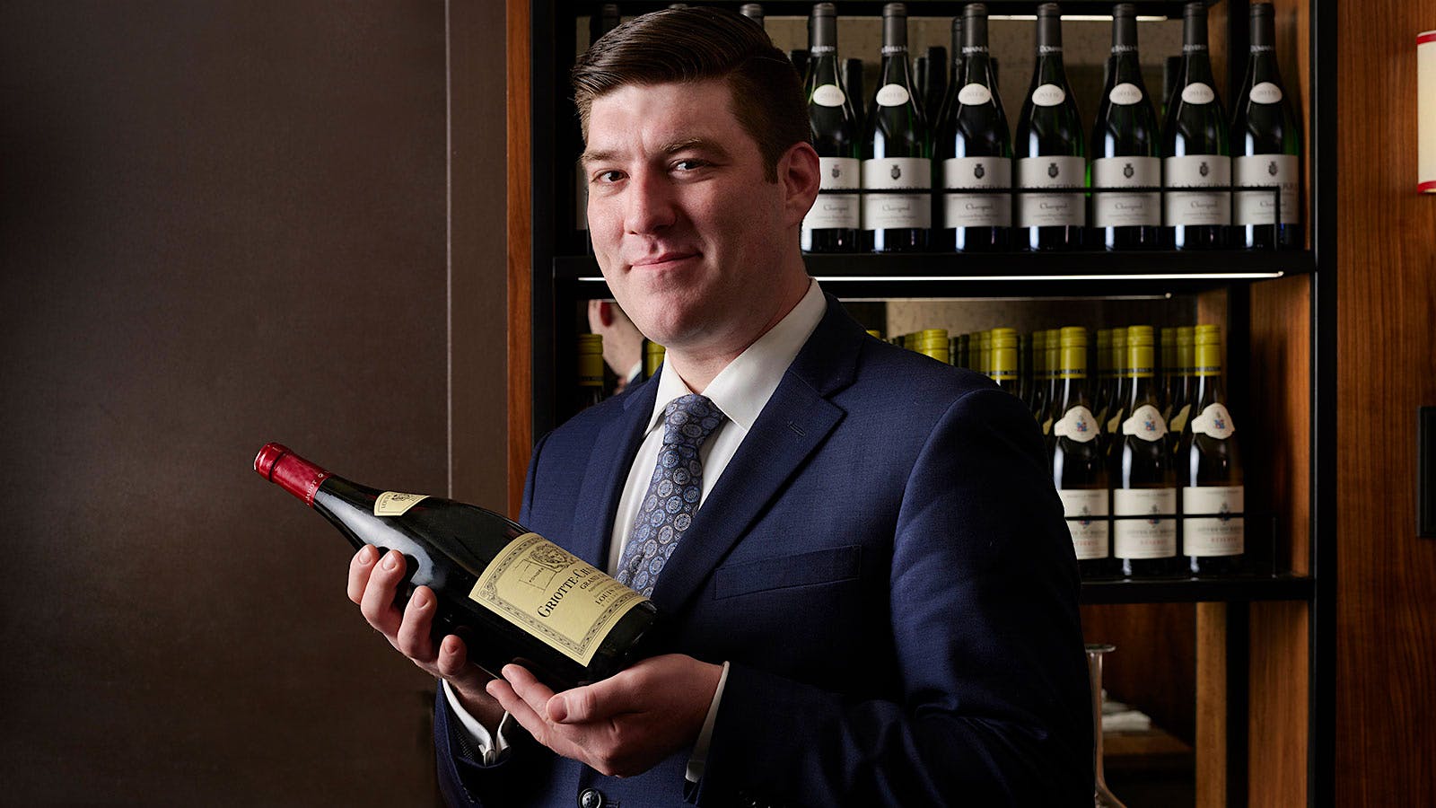 Ian Smedley holds a bottle of Burgundy.