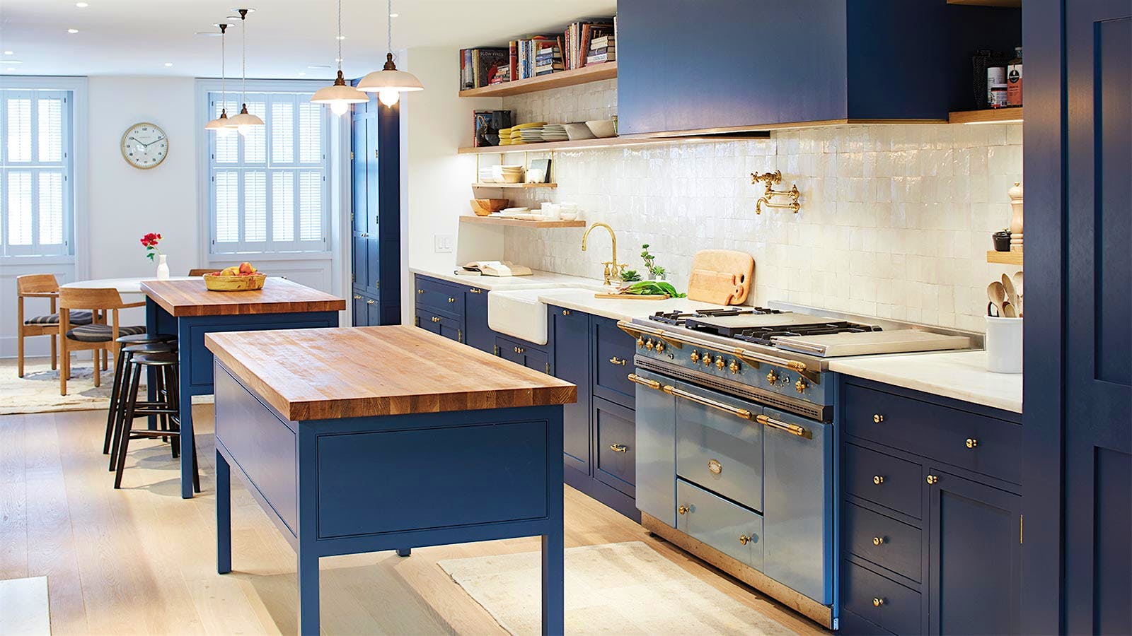 Kitchen with light-reflecting navy-blue walls and light oak floors.