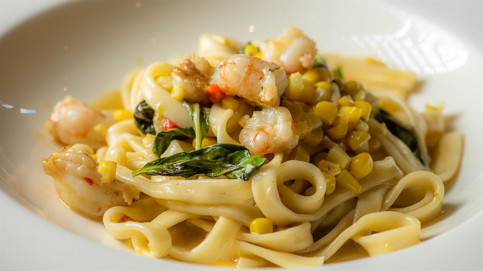 Flat pasta noodles with shrimp and corn