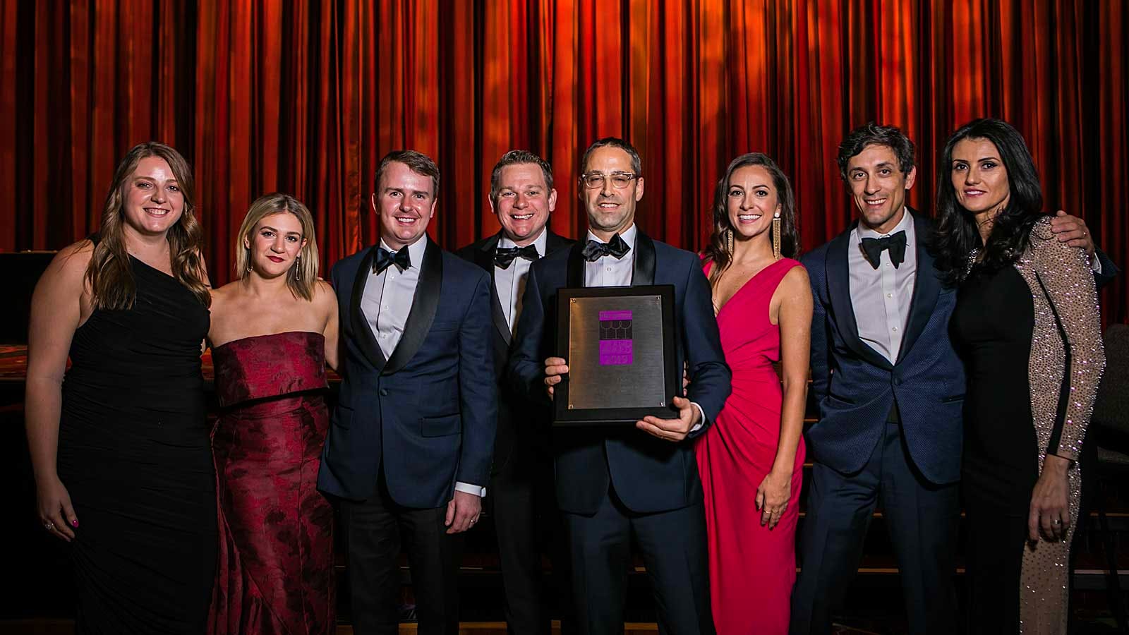 Wine director John Slover (holding plaque) and his team accept the Grand Award for the Pool in New York