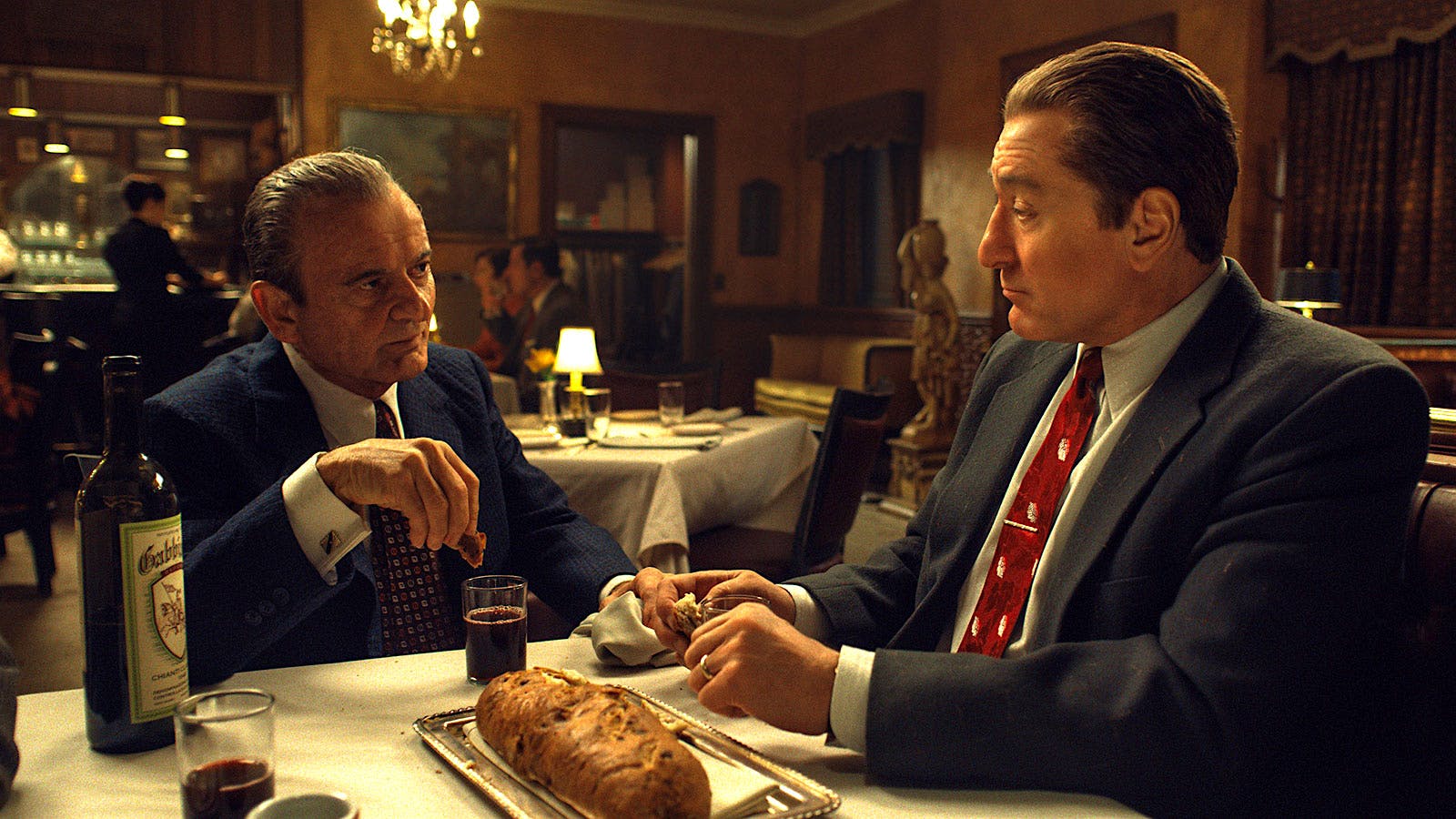 Joe Pesci and Robert De Niro convene over Gabbiano Chianti in a scene in The Irishman.