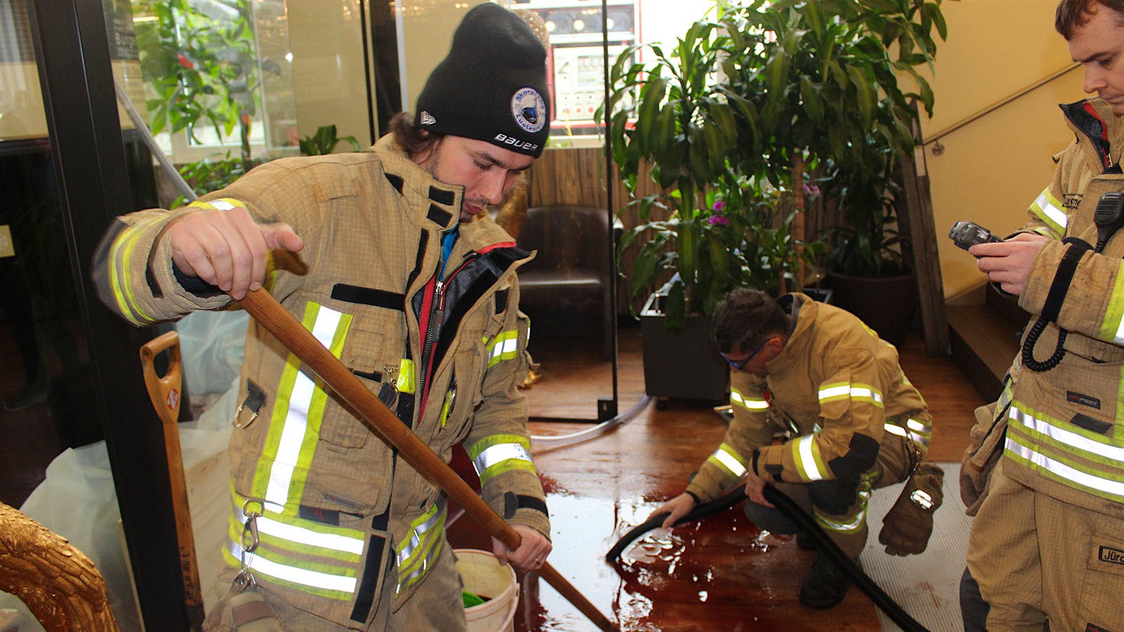 Firemen cleaning up wine spill