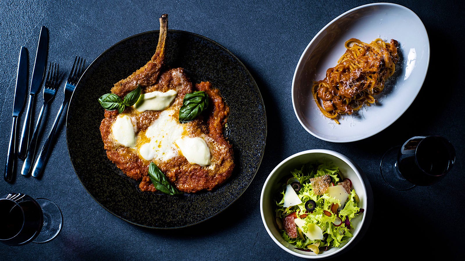 Pork chop–parmesan, bucatini and a side salad