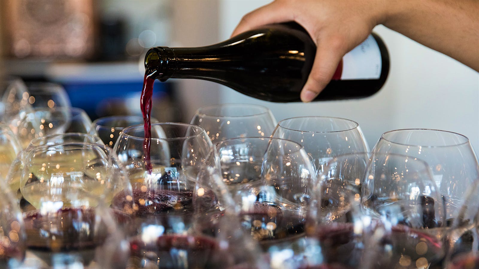 Pouring red wine into glasses