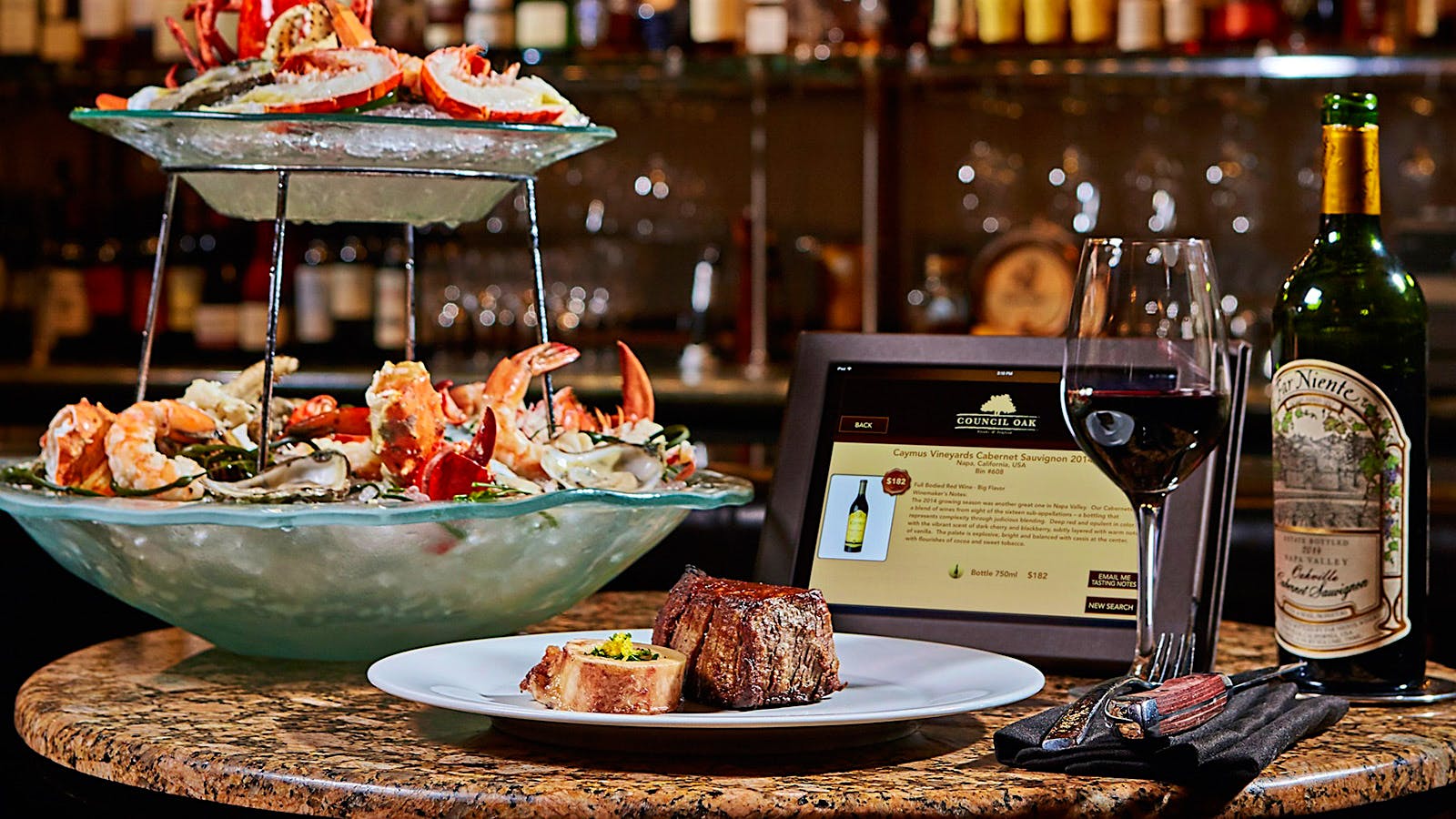 A seafood tower, steak and a bottle of wine at Council Oak Steaks & Seafood