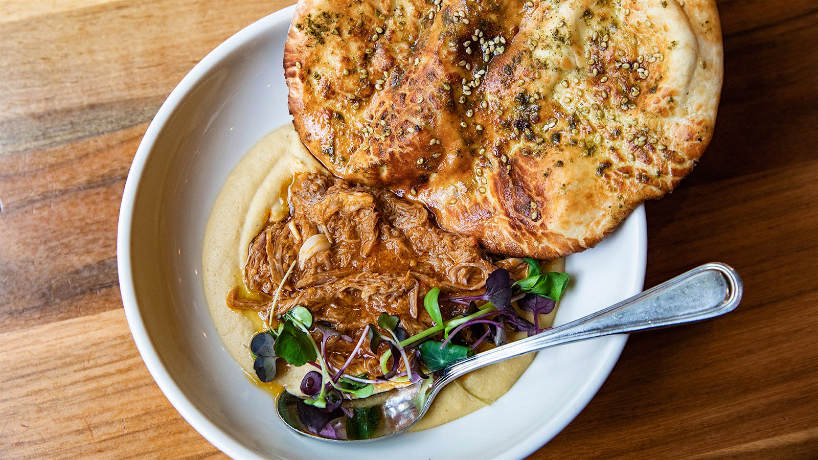 A bowl of hummus with lamb ragu at Aba