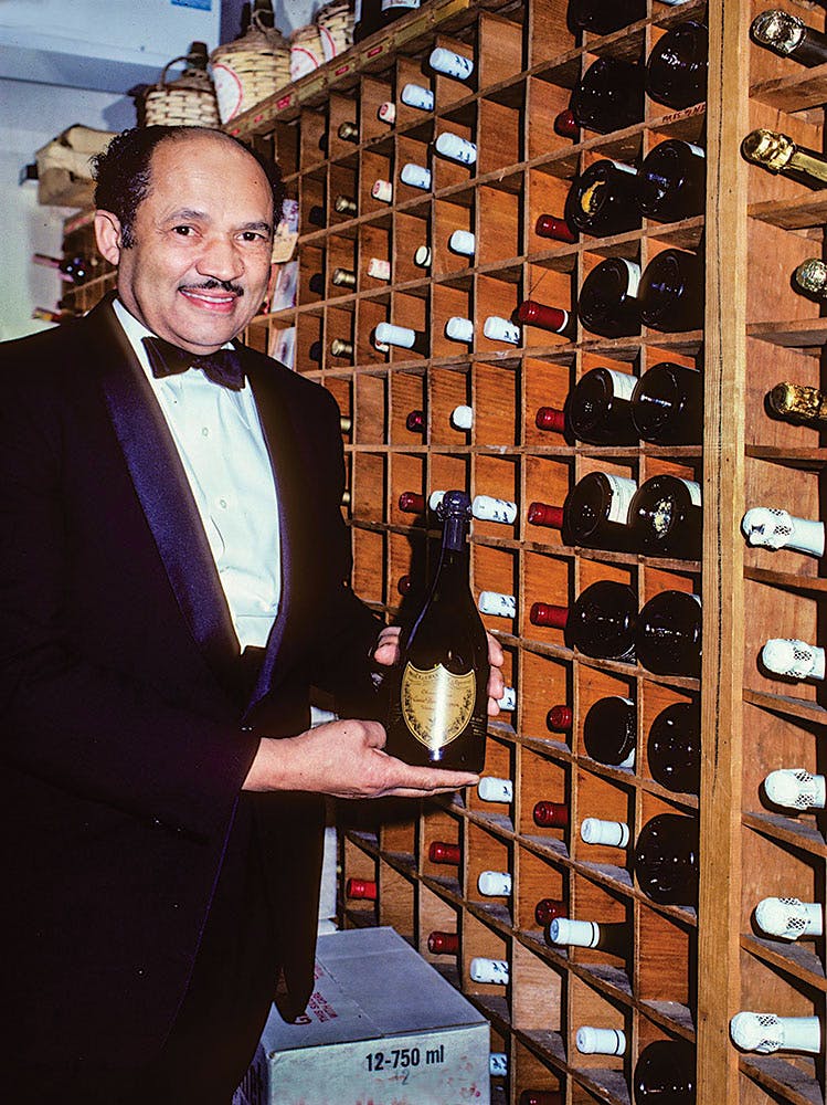 White House head butler Eugene Allen in the 300-bottle White House cellar during the Reagan administration; author Fred Ryan was able to track down never-before-published looks inside the cellar.