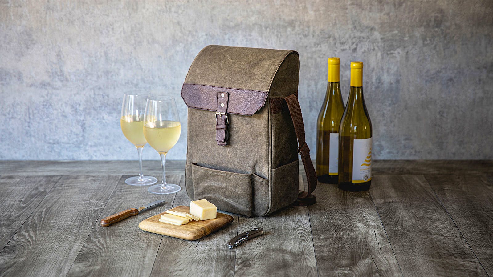 Picnictime Legacy wine and cheese tote, shown with two bottles of white wine, two white wine glasses, cheese board, cheese knife and corkscrew