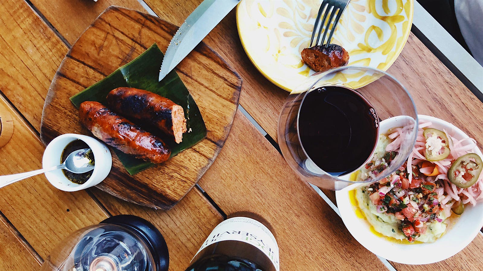 An overhead shot of food and wine at Amara at Paraiso