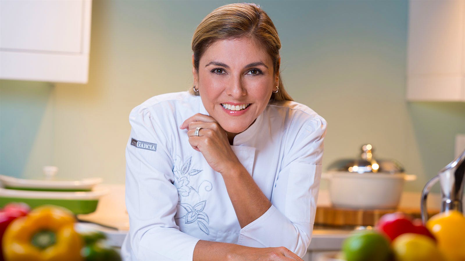 Chef Lorena Garcia in the kitchen in her chef coat