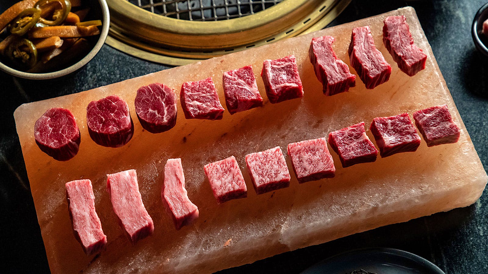 Small pieces of meat ready to be cooked on the signature grill at Cote Korean Steakhouse