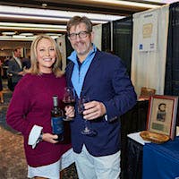 Golfer-vintner Cristie Kerr and husband Erik Stevens holding a bottle of Kerr Cellars wine