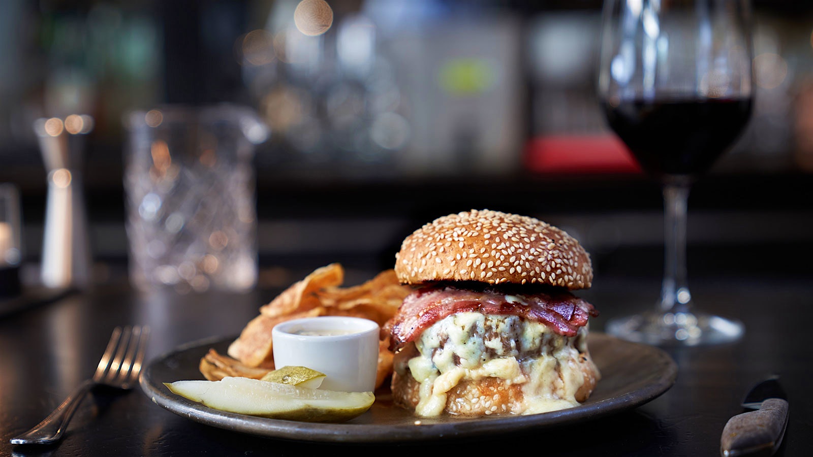  Gramercy Tavern burger next to a glass of red wine 