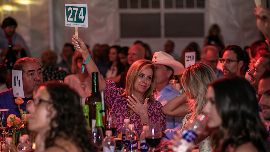 Alden Lagasse, joined by her husband, chef Emeril Lagasse, left, was one of the bidders at the live auction.