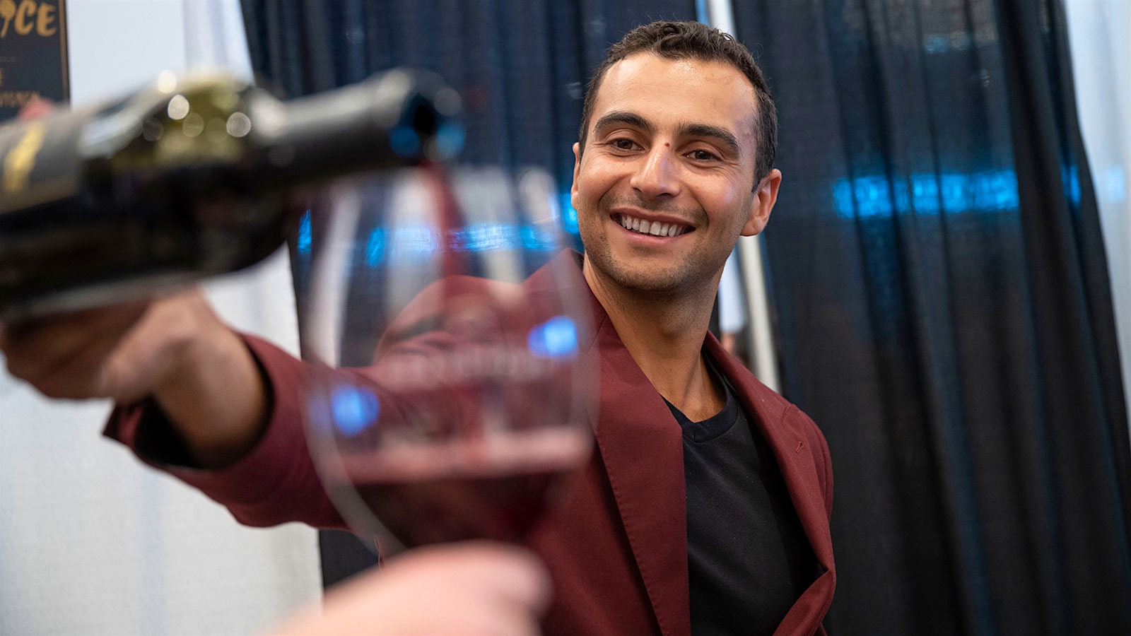  Portrait of The Vice co-founder and winemaker Malek Amrani pouring a 2019 Napa Cab