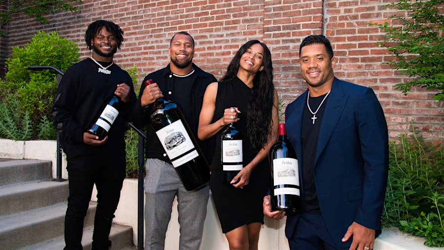 From left: Denver Broncos Javonte Williams, Bradley Chubb and Russell Wilson, with Wilson's wife, Ciara