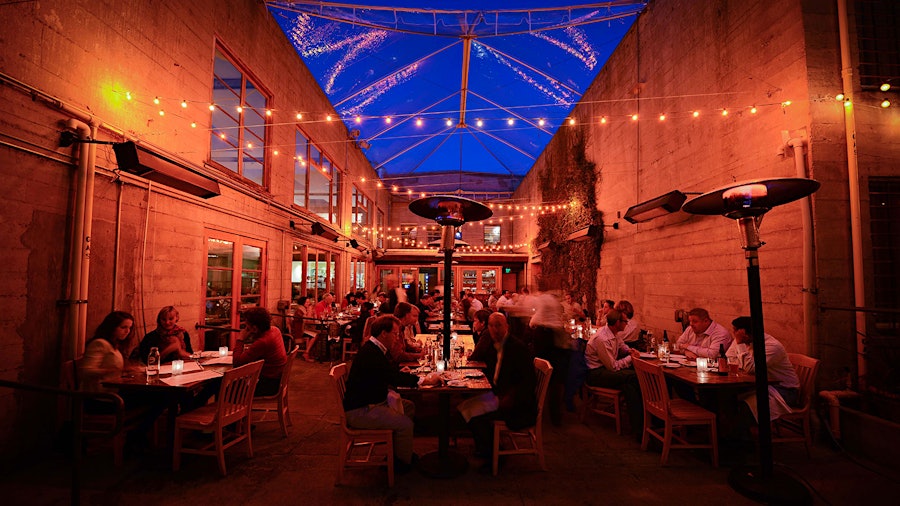 In the evenings, outdoor dining at Foreign Cinema is accompanied by a movie being projected on one wall of the patio area.