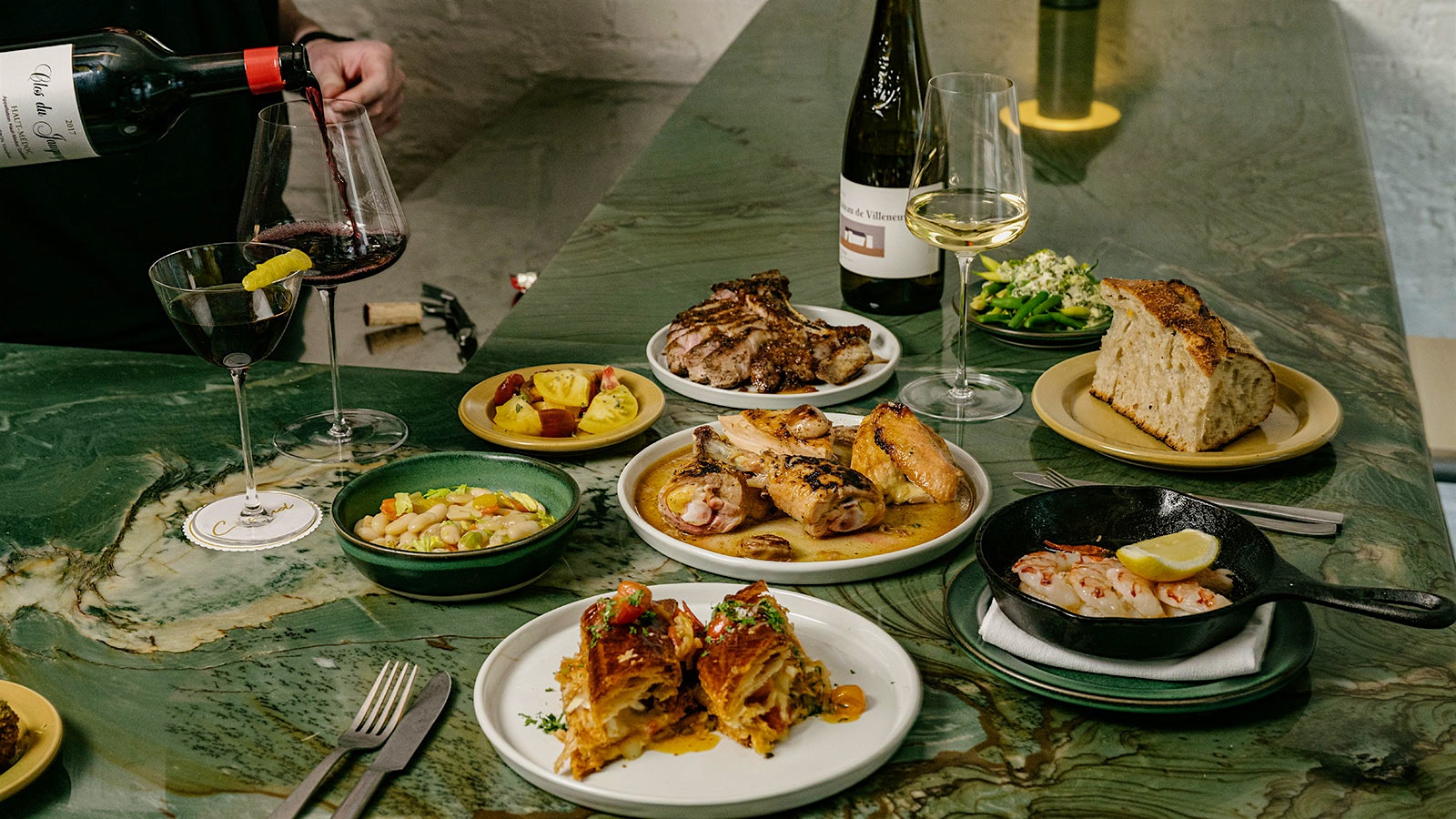  A selection of Claud's dishes and red and white wines on the emerald-hued quartz bartop