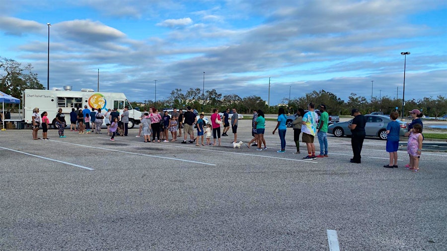 Florida residents line up for meals from a World Central Kitchen food truck; the charity group had workers and supplies in place two days before the storm.