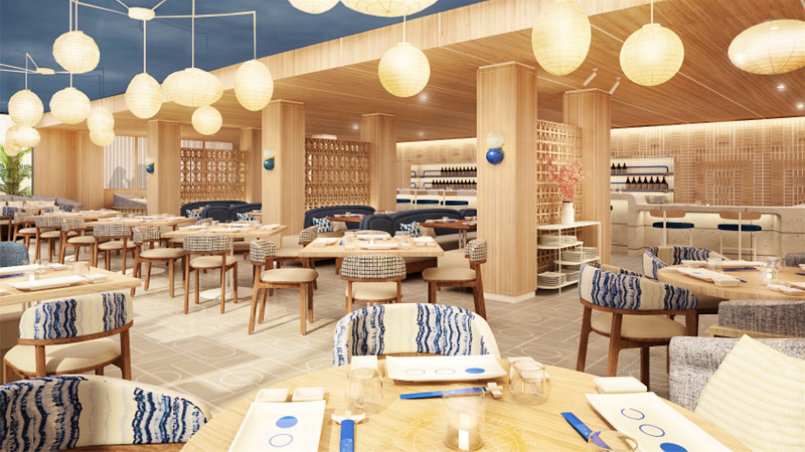  The dining room at the Japanese Bocce Club, designed in light wood, with a blue ceiling and blue accents on the chairs.