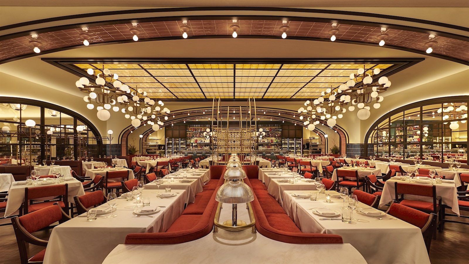 The French brasserie–inspired dining room at Le Select in Chicago, with detailed such as tiled ceiling arches and mirrored walls