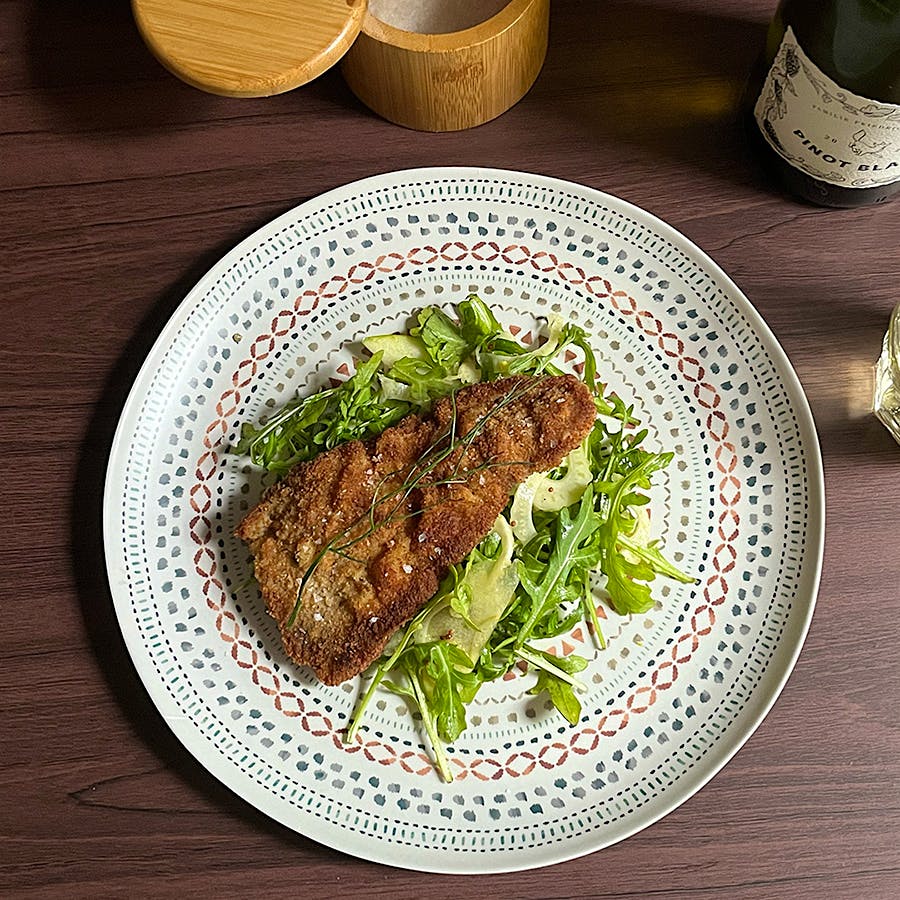 A wine with bright citrus flavors and notes of sea salt makes a lively accompaniment, acting like a squeeze of lemon over the meat and fresh greens.