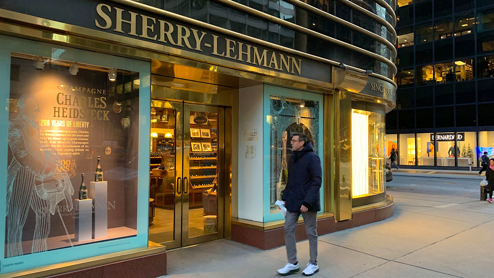  A pedestrian walks by the closed store front of Sherry-Lehmann
