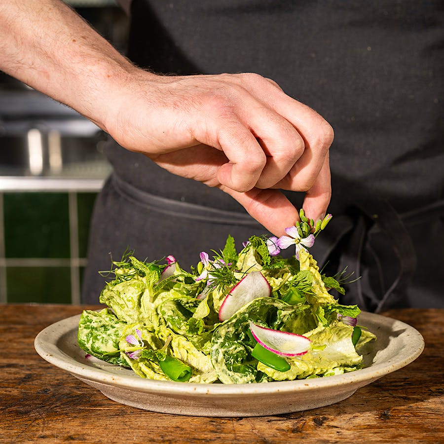 Chef Bryan Oliver's spring salad is packed with fresh herbs and topped with delicate blossoms.