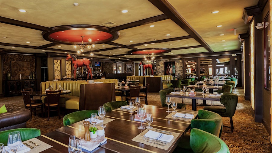 The luxury resort's main restaurant, now called Double Barrel Steak by David Burke, features many of the chef's hallmarks, including red horses incorporated into the décor and Himalayan salt–aged steaks.