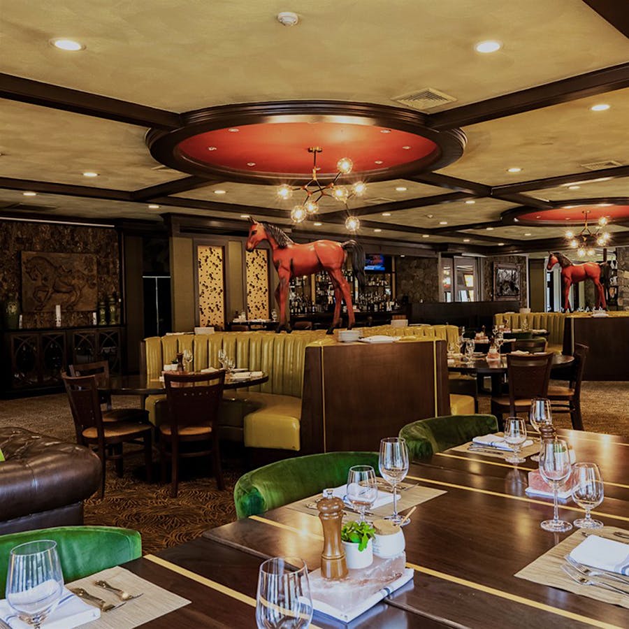 The luxury resort's main restaurant, now called Double Barrel Steak by David Burke, features many of the chef's hallmarks, including red horses incorporated into the décor and Himalayan salt–aged steaks.