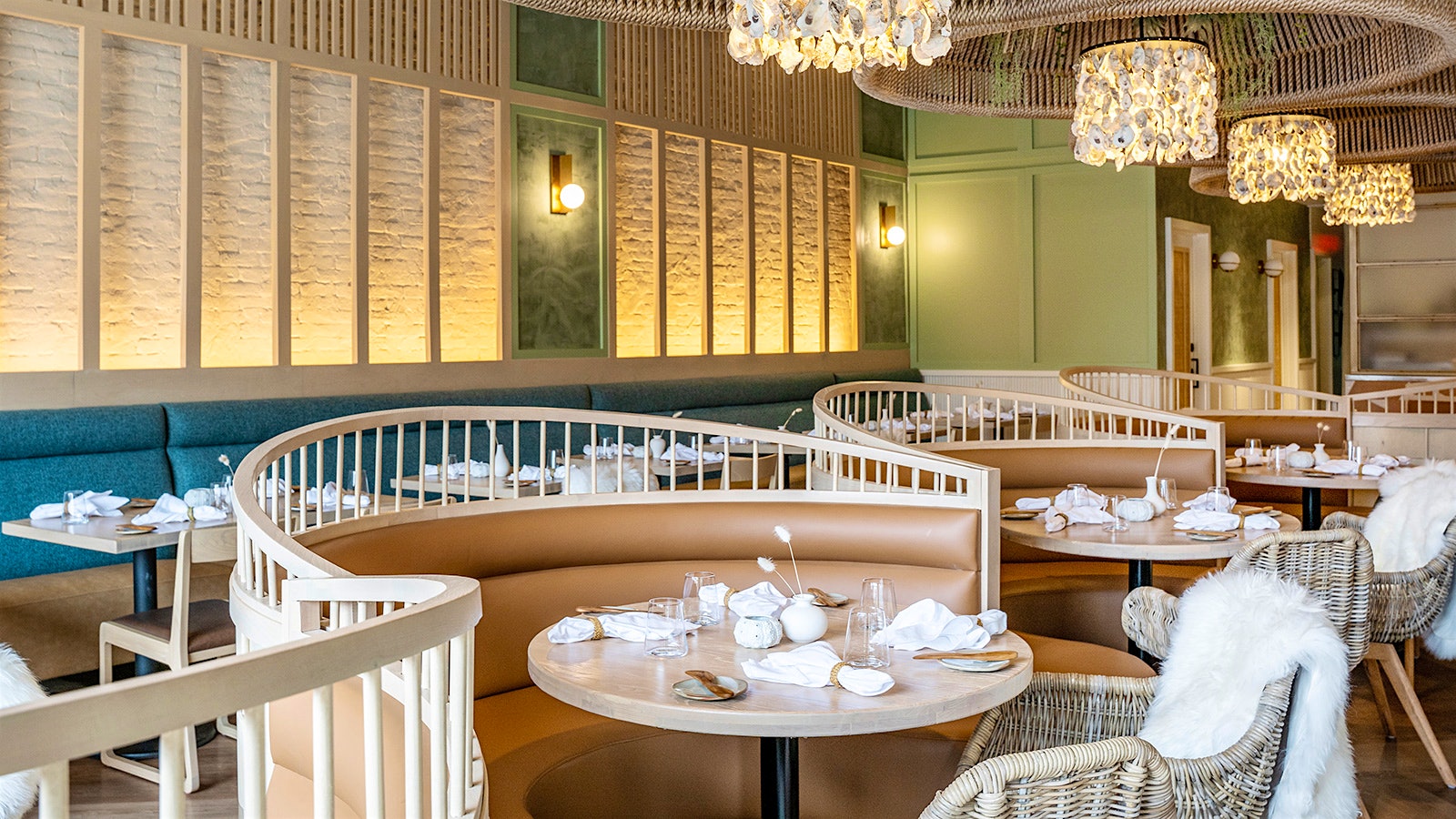  The dining room at Quarter Acre, with wicker chairs, tan booths and a white brick wall
