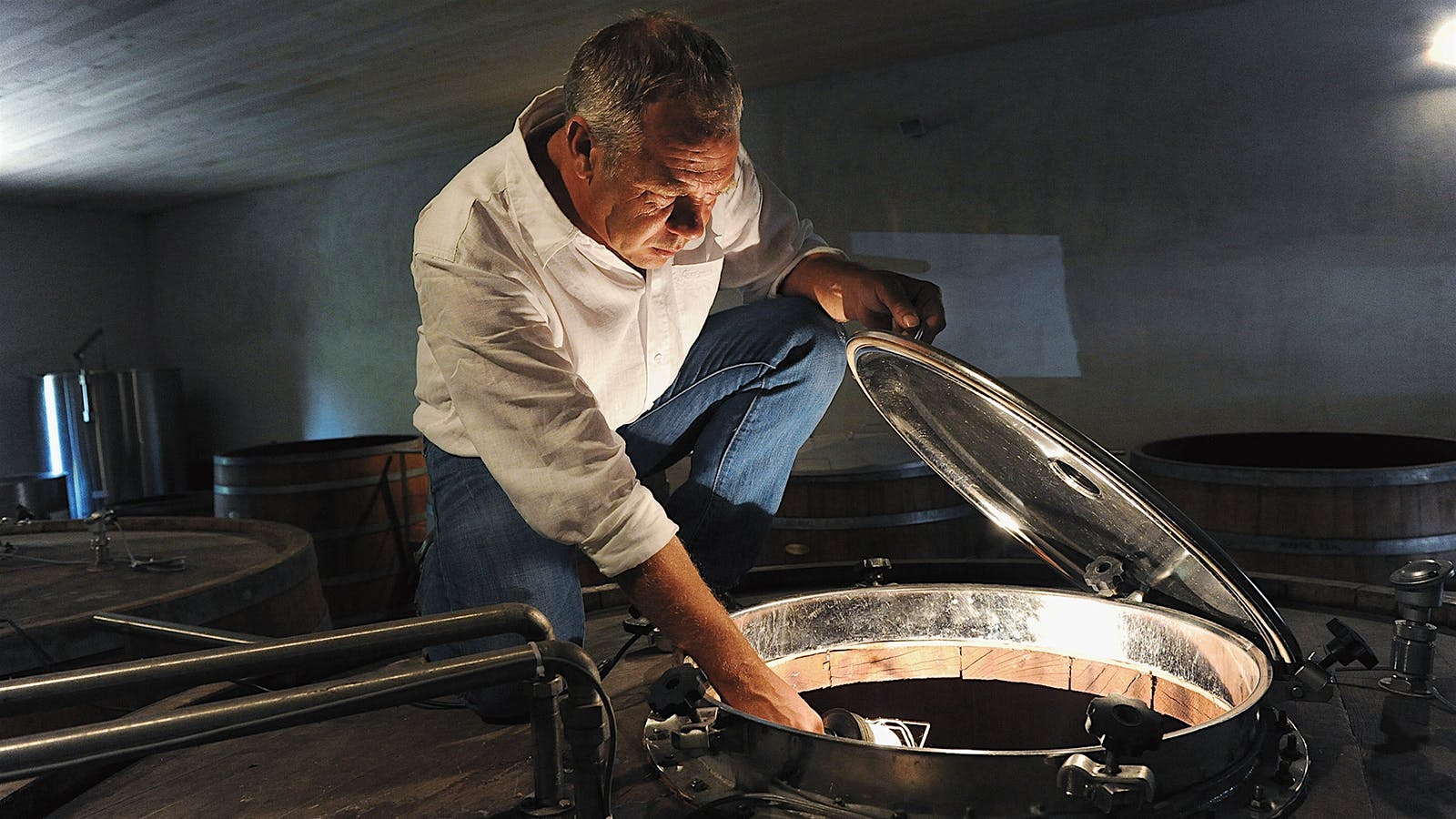 Stéphane Derenoncourt inspects fermenting must at Domaine de l'A in Bordeaux.