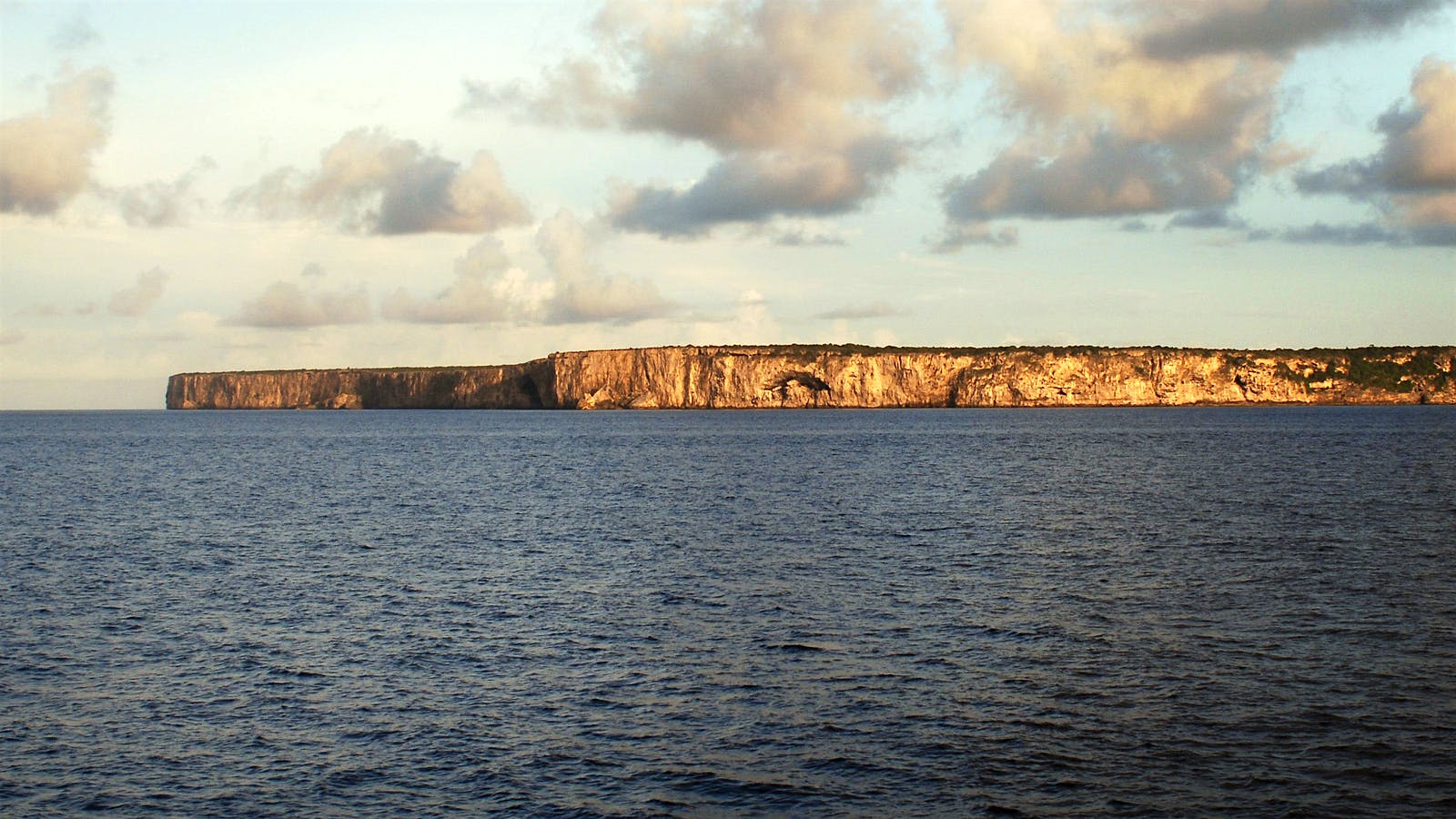 The sun sets, shining the remaining daylight to the cliffs of Isla de Mona, Puerto Rico