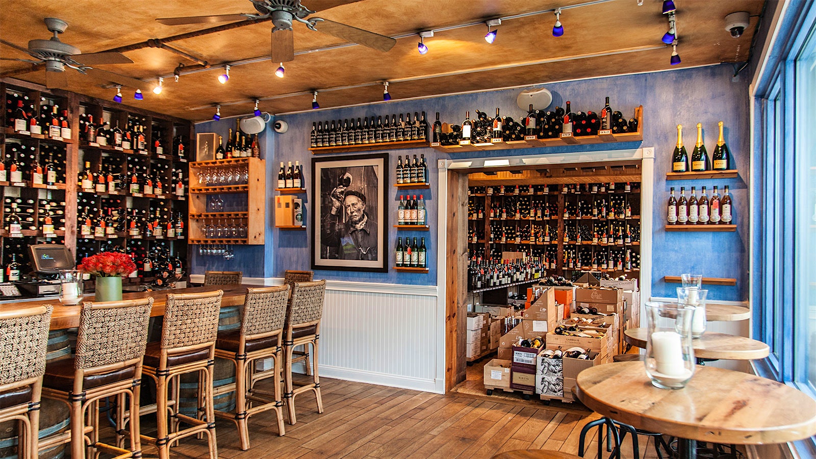  A look at the bar and cellar of Bleu Provence, with blue walls and wine bottles covering almost every surface.