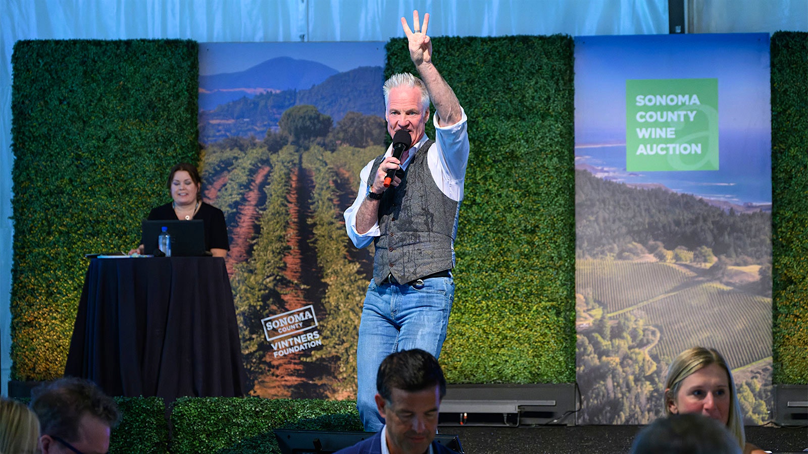  Auctioneer John Curley encouraging bids from the stage at the Sonoma County Wine Auction