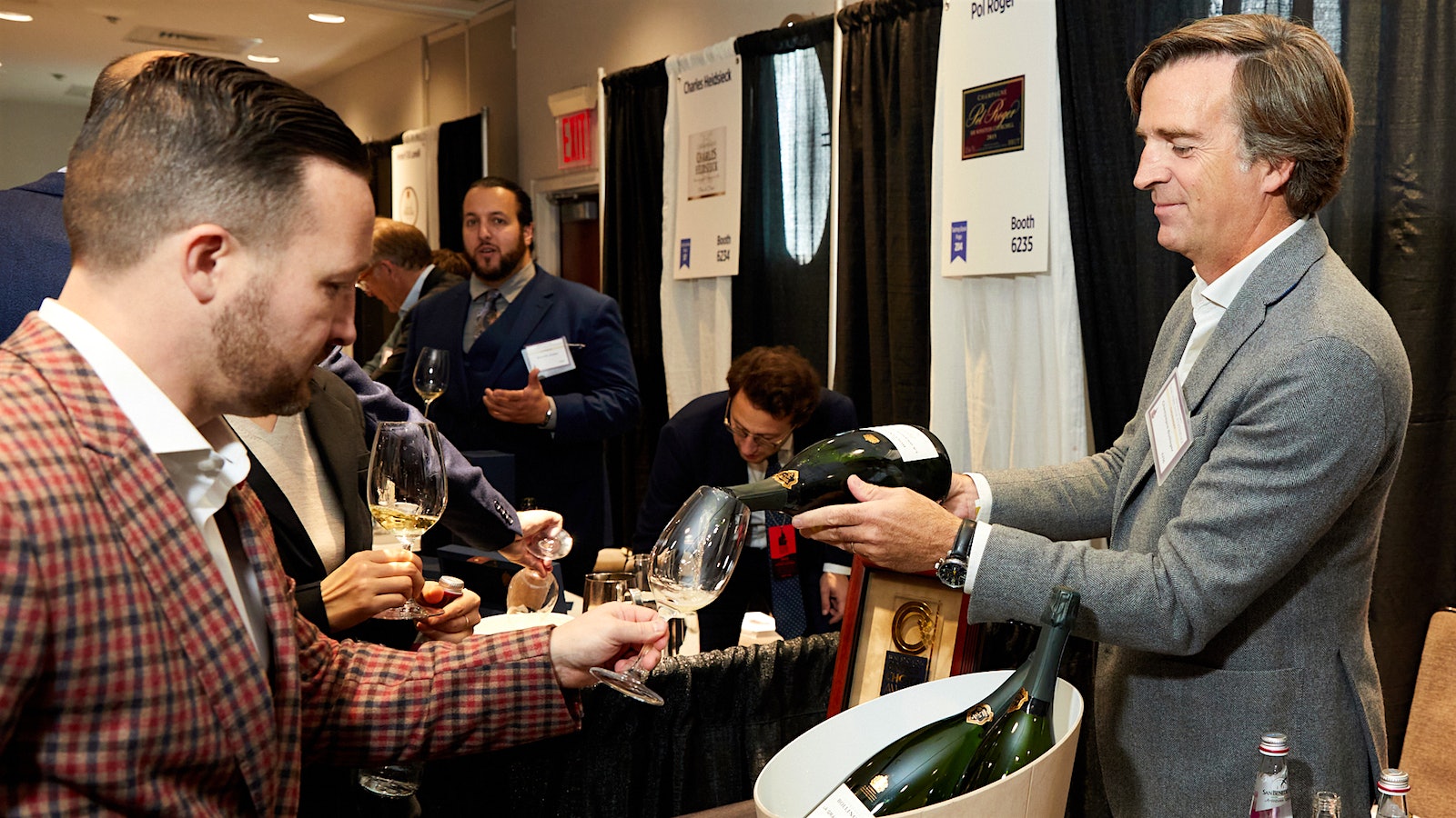  Charles-Armand de Belenet, general manager of Champagne Bollinger, pouring La Grand Année 2014 for a guest at Wine Spectator's Grand Tasting