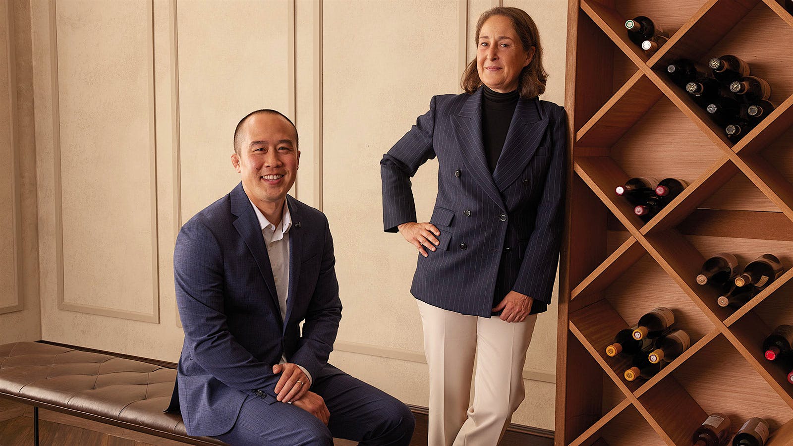  Kurtis Ogasawara of Robert Mondavi and Albiera Antinori of Antinori near a wood rack of wines.