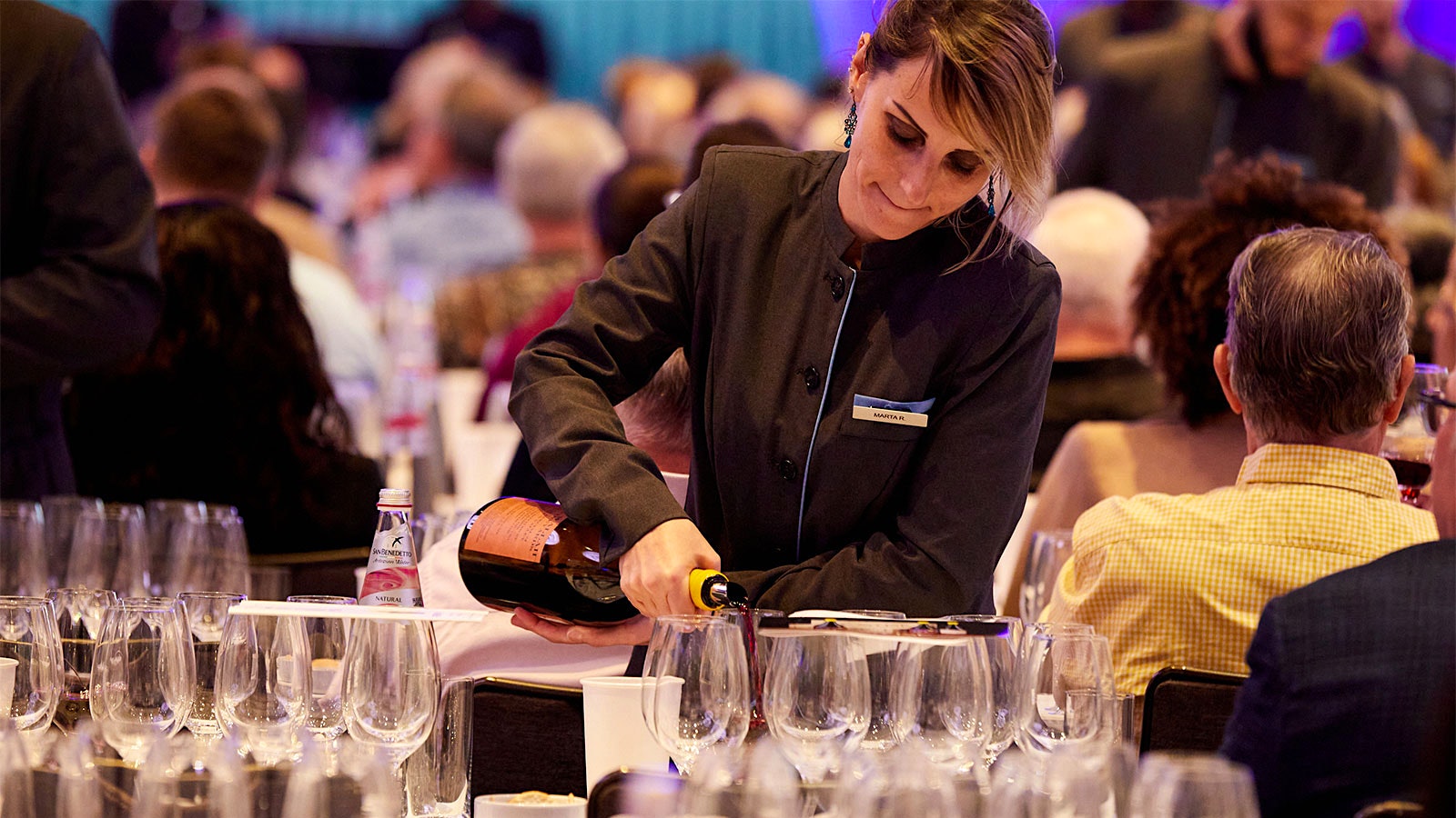  A server filling wine glasses during the seminar at the 2023 New York Wine Experience seminars