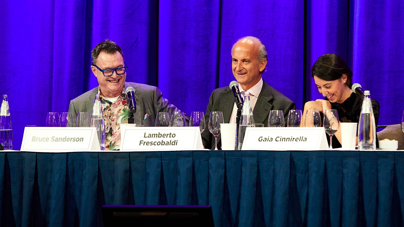  Wine Spectator senior editor Bruce Sanderson seated on stage with Marchesi Frescobaldi president Lamberto Frescobaldi and Masseto winemaker and cellar master Gaia Cinnirella
