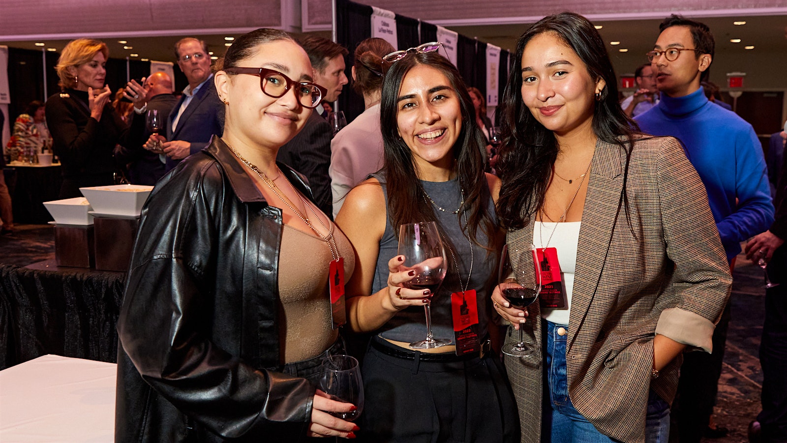  Three women in their 20s attending the Wine Spectator Grand Tasting together