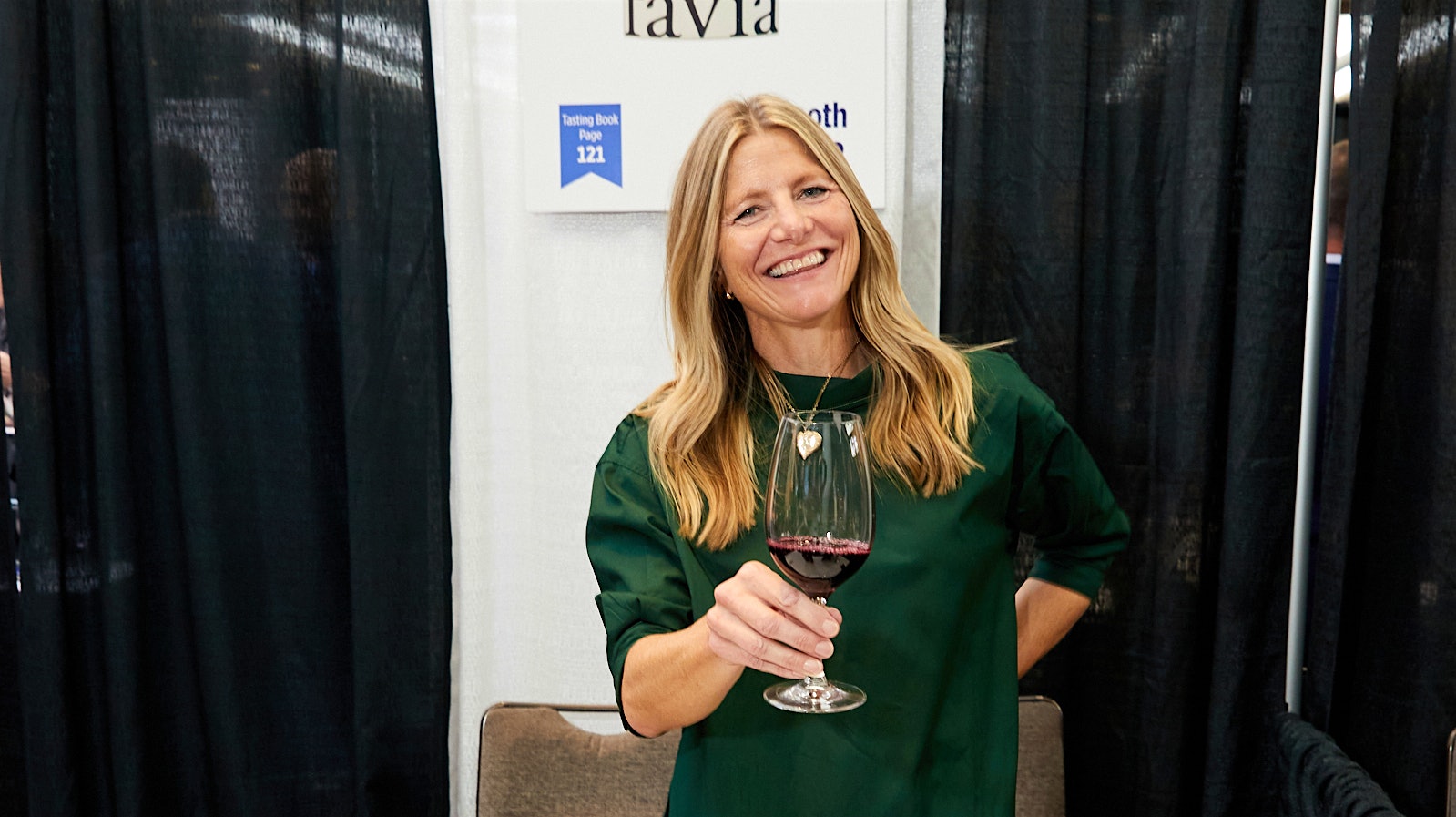  Favia co-founder and viticulturist Annie Favia holding a glass of red wine at the Wine Spectator Grand Tasting