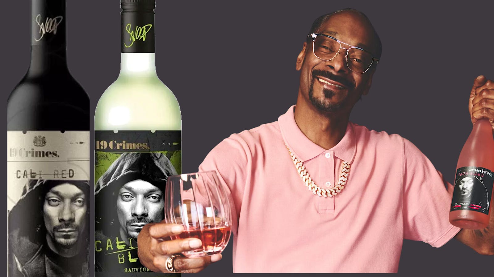 Snoop Dogg, wearing a pink shirt, holds a glass and bottle of 19 Crimes Cali Rosé, while posed next to bottles of his Cali Red and Cali Blanc